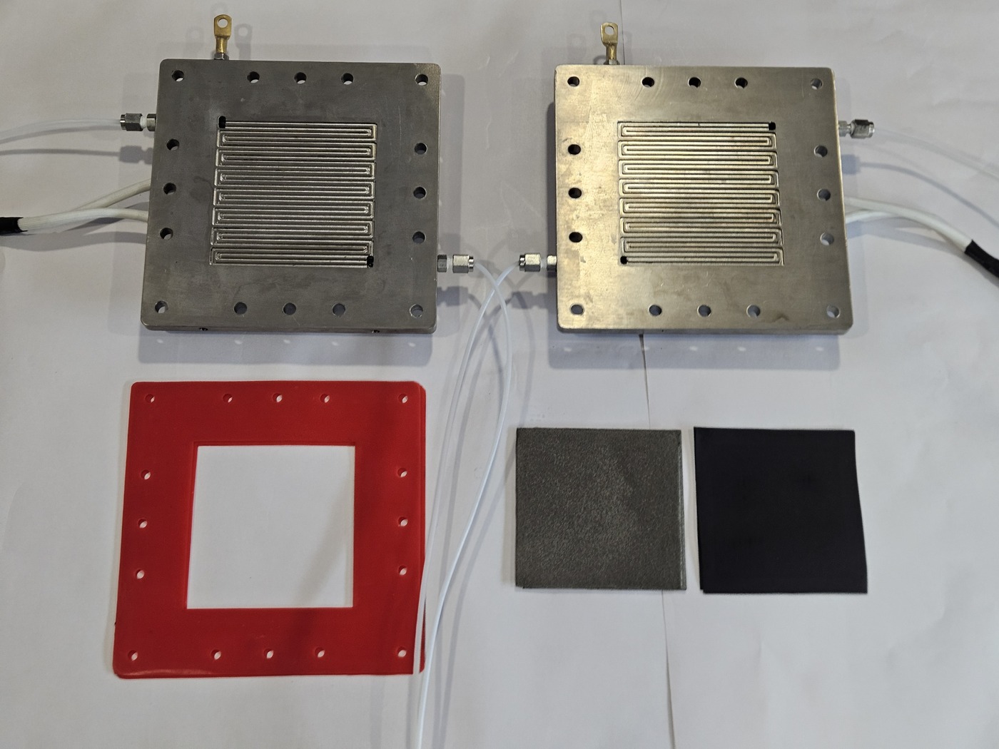 Titanium plates and electrode media before assembly — SSI CO₂RR brochure physical page 3